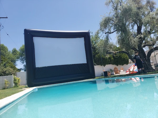 Backyard outdoor movie night with projector and screen